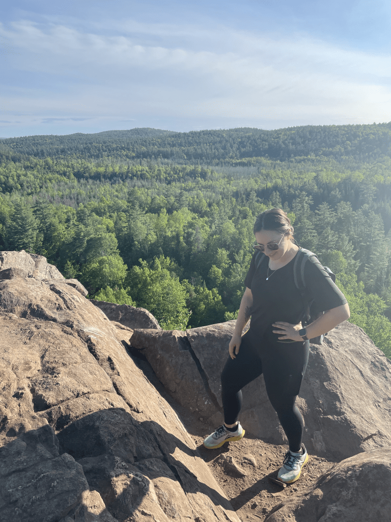Tori Dudys standing on the top of a big hill in Calabogie, Ontario. 